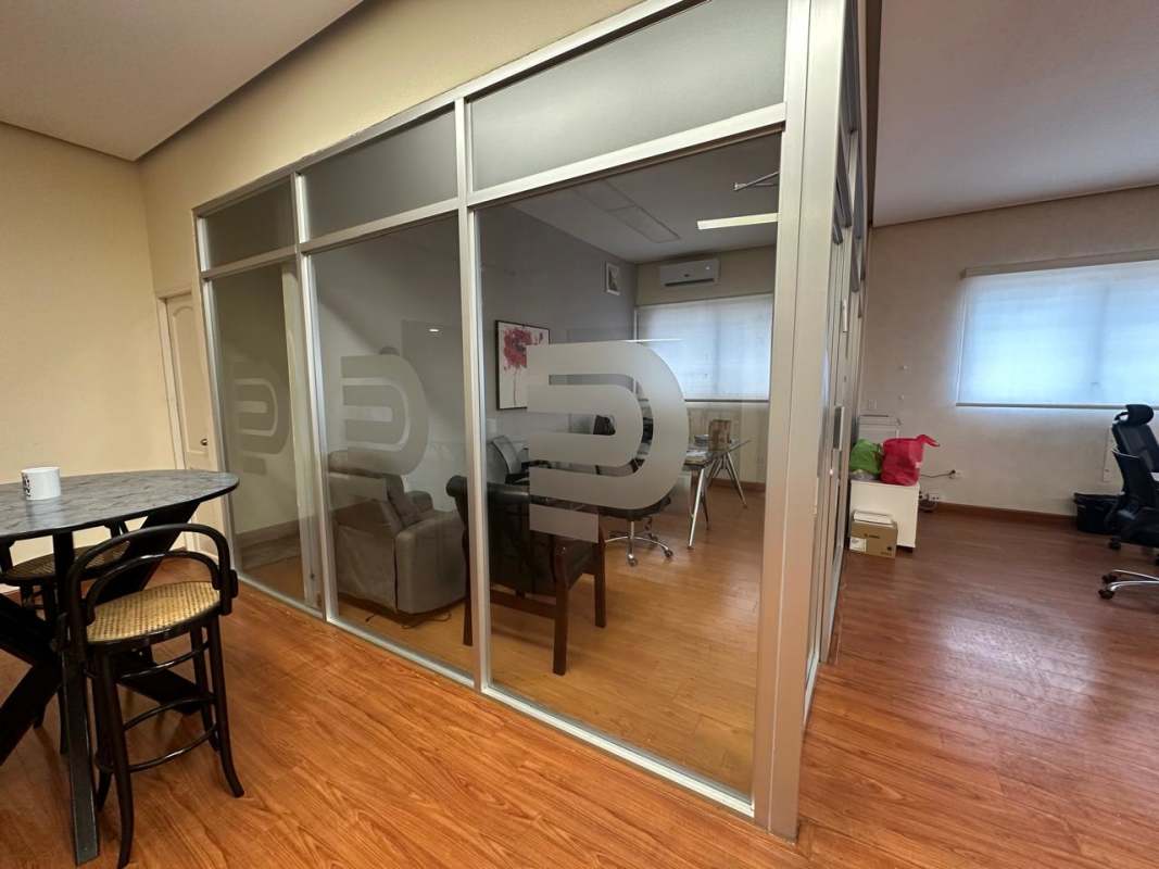 Modern enclosed offices with glass walls inside a commercial galera, Vía Transístmica Panama