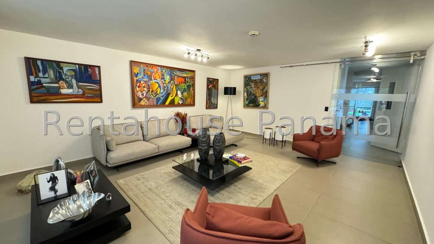 Spacious outdoor covered terrace overlooking green garden and pool Obarrio Panama