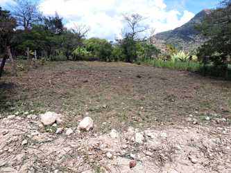 Vacant land with paved road frontage and mountain background ideal for countryside home in El Valle Panama.