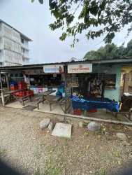 Storage room with shelves filled with merchandise and large appliance inside grocery store Bugaba David