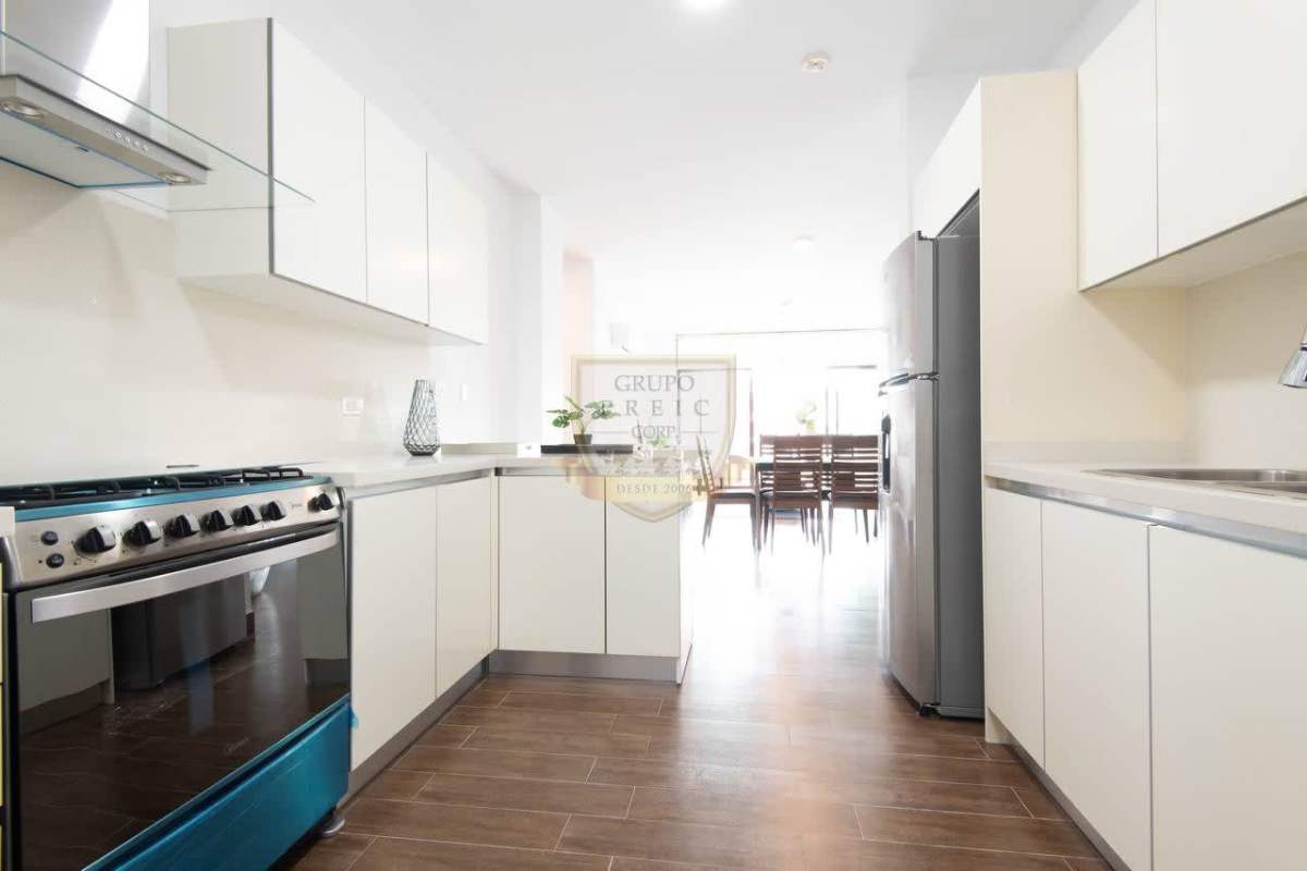 Kitchen with stainless stove and cabinets overlooking dining area in PH Costamare Panama