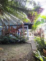 Private dock with boat on calm Caribbean Sea with mountain backdrop in Portobelo Panama