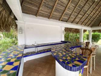 Living room with tile floors, large windows, and patio doors in Coronado Panama beach house