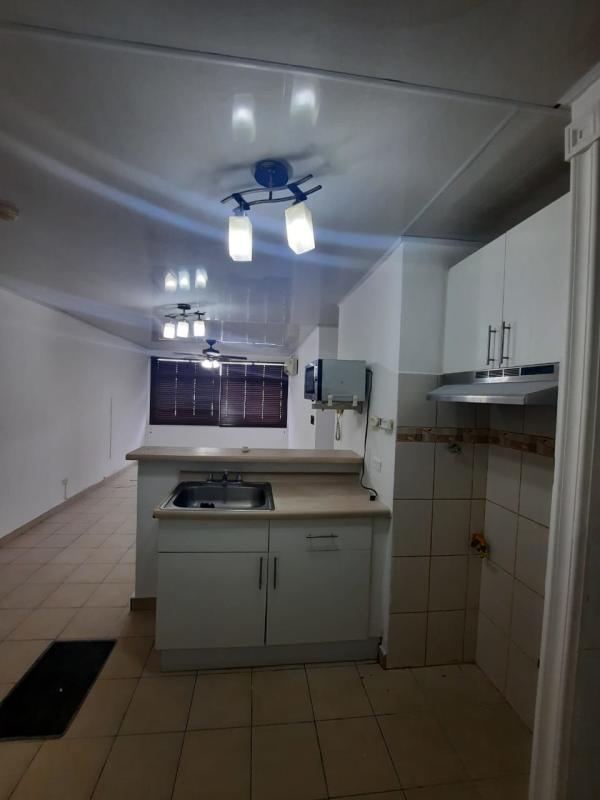 Kitchen with island, tile floor, cabinets PH Roca Park Panama City