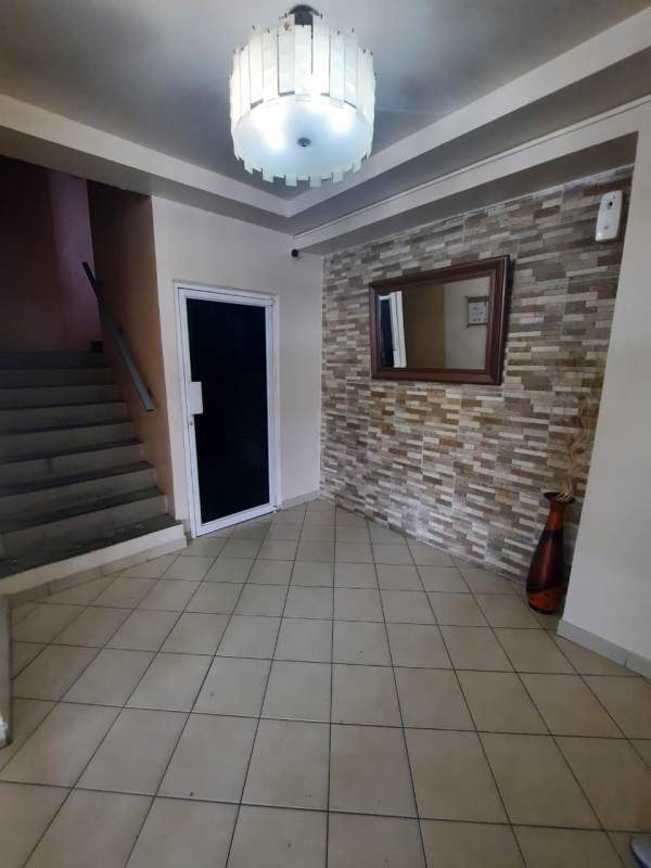Bedroom with blue curtains, tiled floor, split AC and ceiling fan at PH Roca Park El Crisol Panama