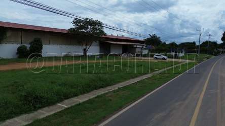 Large industrial warehouse built with red metal roofs and driveway access in Los Santos Panama