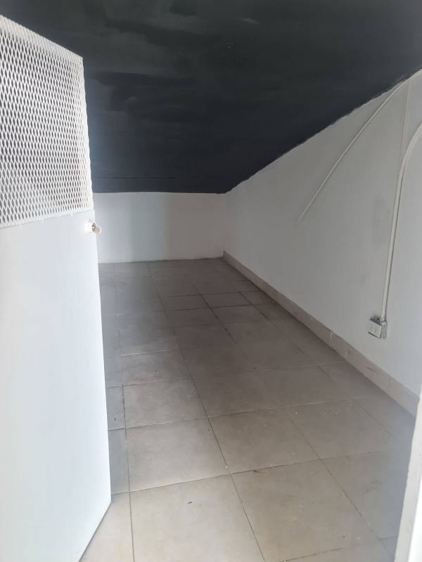 Small storage rooms with tiled floor and mesh doors inside PH Sorrento commercial parking area Panama