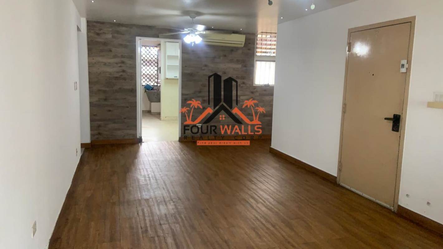Living dining area with wood floor accent wall PH Monserrat Via Argentina Panama City