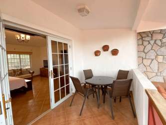 Bathroom with tile walls, corner shower and blue sink in Coronado Panama