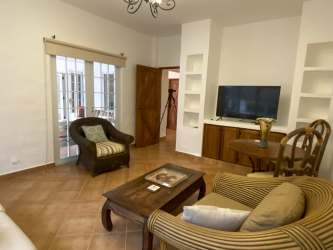 Bedroom with tile floors, large windows, ceiling fan in Coronado beach house Panama