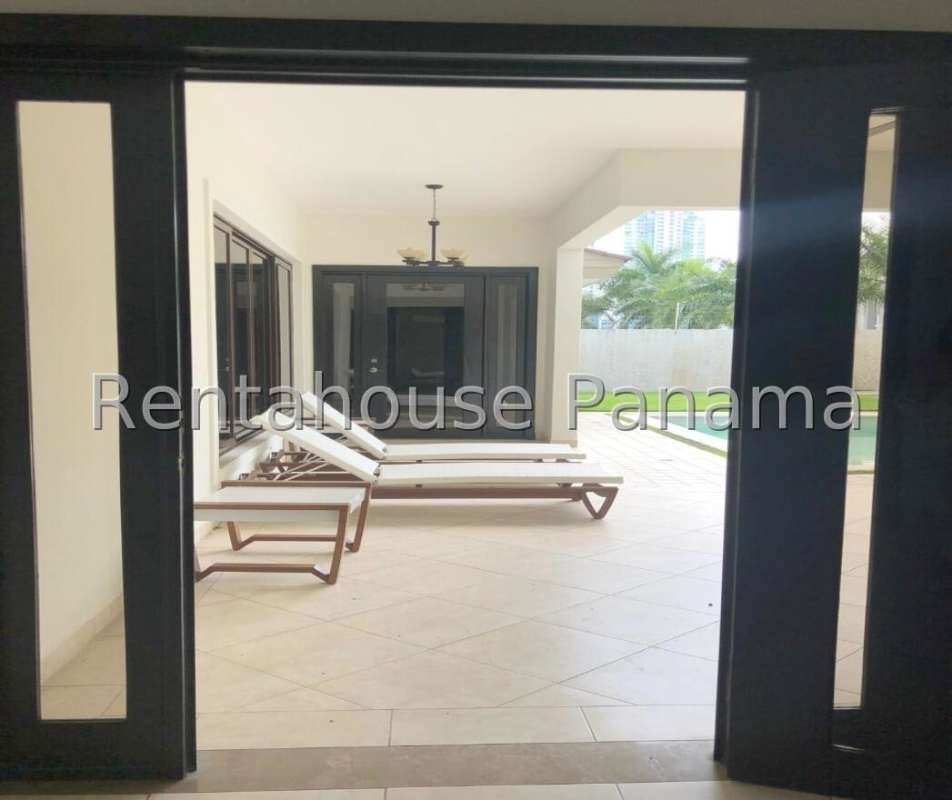 Outdoor covered patio overlooking private pool and lush gardens in luxury Costa del Este residence