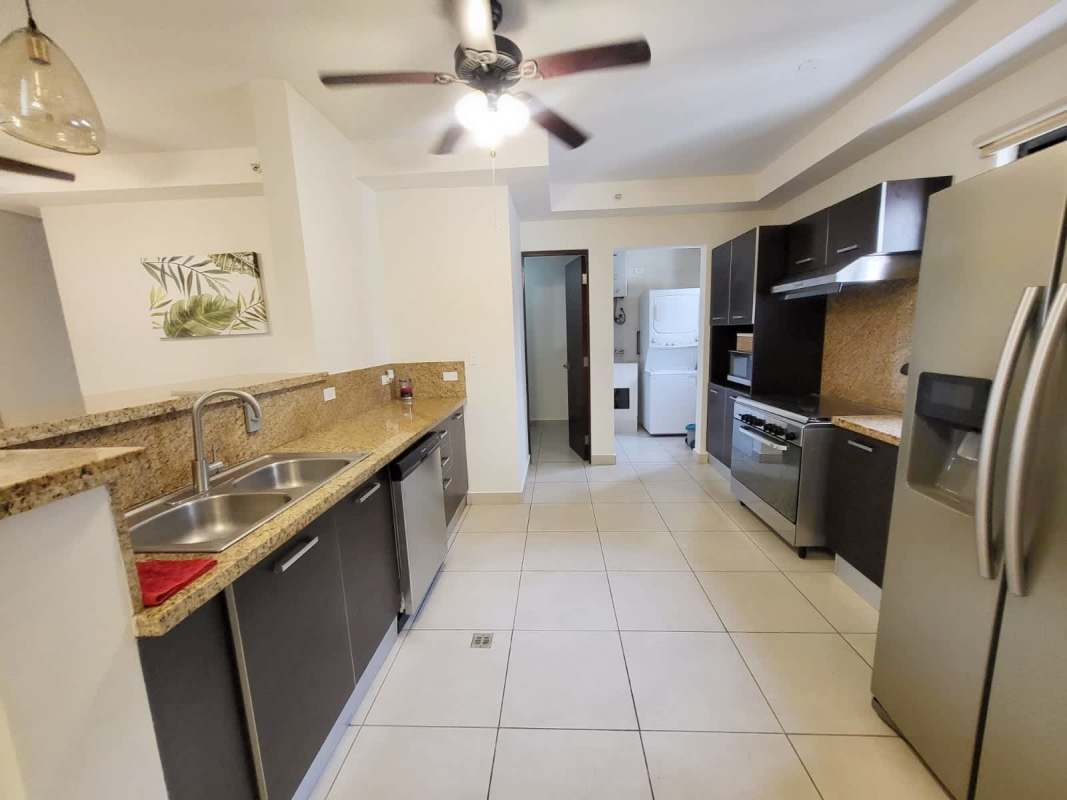 Modern kitchen with granite countertops appliances and tile floor at Embassy Club Clayton