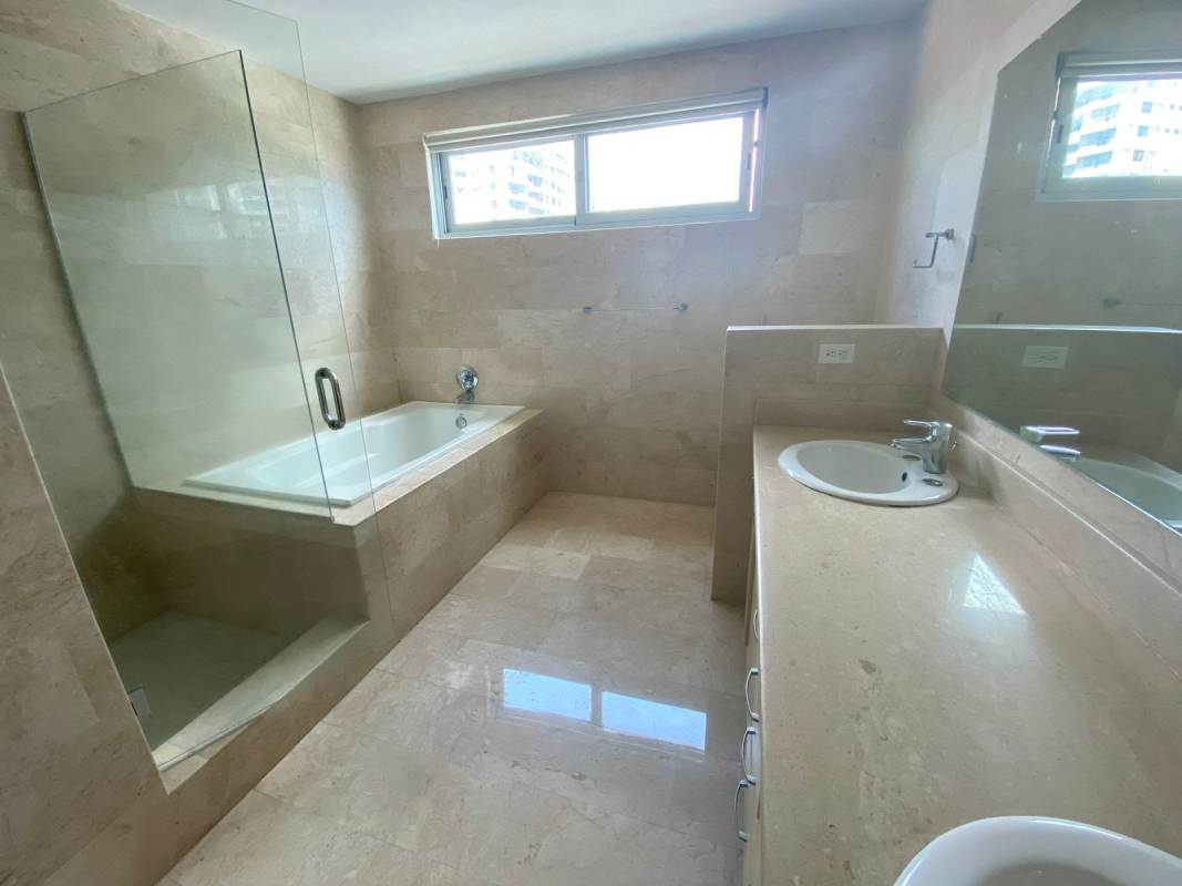 Luxurious bathroom with marble tiles, bathtub and large mirror in PH Marabierto Marbella Panama City