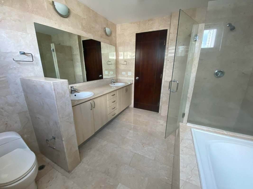 Luxurious bathroom with double vanity sinks, marble finishes, and glass shower PH Marabierto Marbella Panama