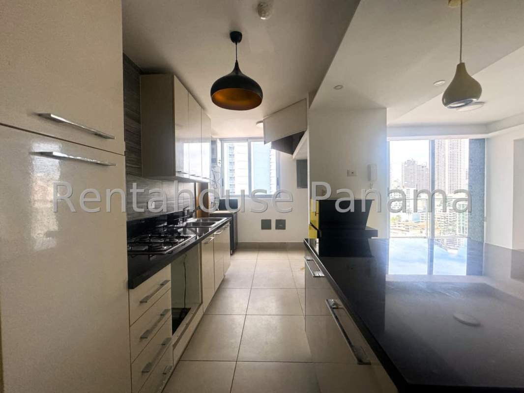 Modern open kitchen with granite counters and pendant lights in Obarrio Panama apartment