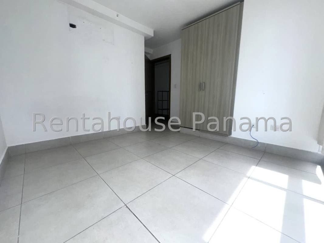 Modern bedroom with large windows and skyline views in PH Park City Obarrio