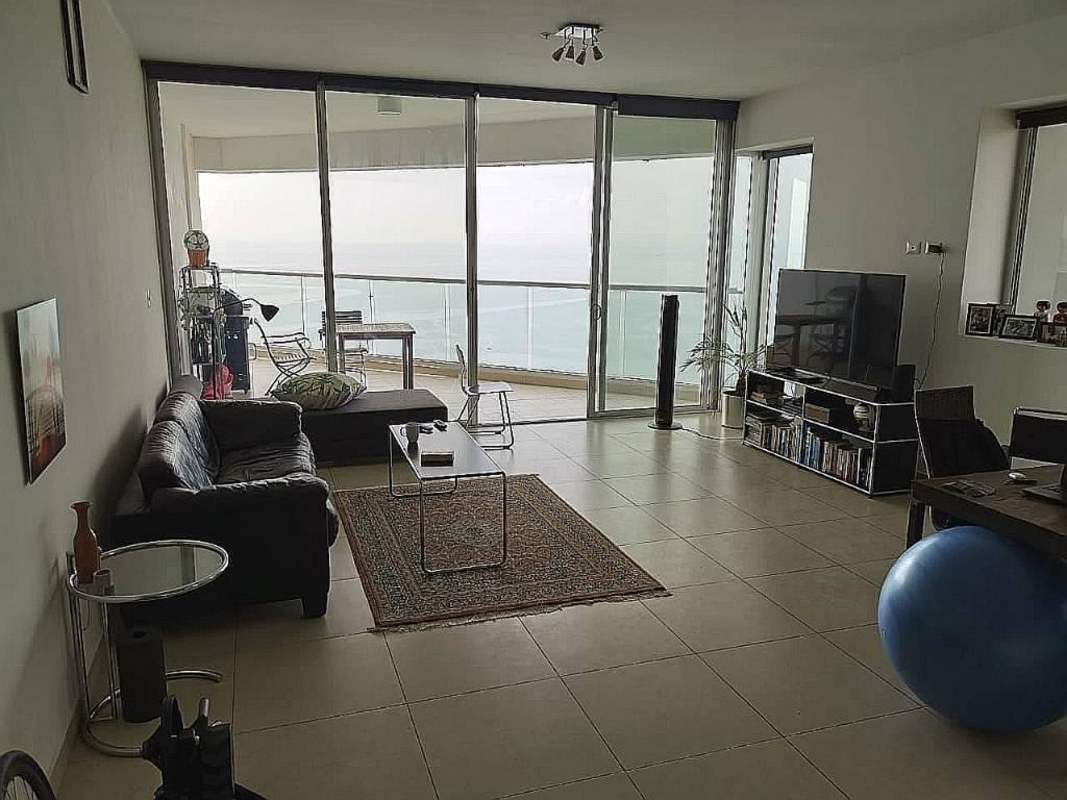 Aerial view of PH Rivage Tower and waterfront Avenida Balboa Panama City at sunset