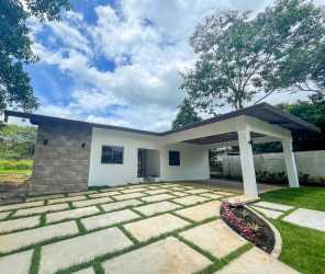 Paved driveway with covered carport and minimalist facade of house for sale San Pablo David