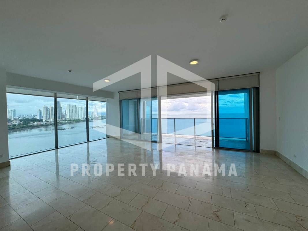 Spacious modern living room with marble floors and large windows overlooking Pacific Ocean in PH Grand Tower Panama