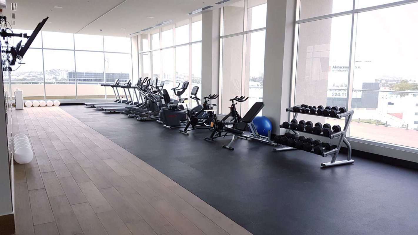 Fitness center with cardio machines, weights, and panoramic city view PH Costa del Mar Panama