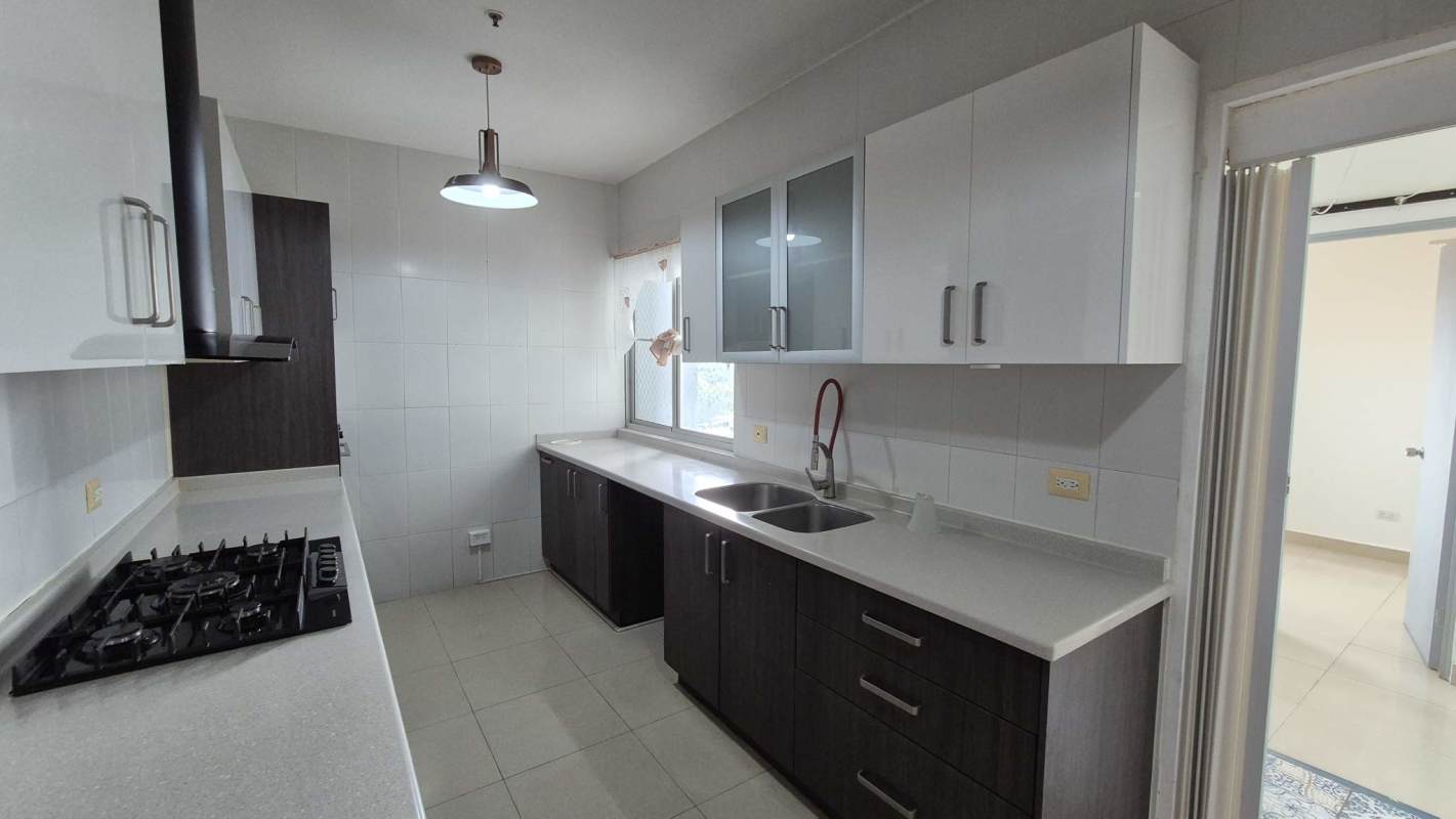 Bedroom with built-in wardrobe, AC unit, tile floors, large window PH Window Tower Panama City