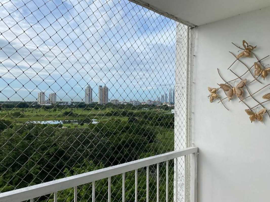 Balcony view with protective netting, city skyline and green landscape, PH Mystic Blue Juan Díaz
