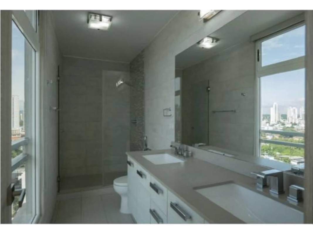Bathroom with double sinks, large mirror, shower, city view window in PH The Towers Panama