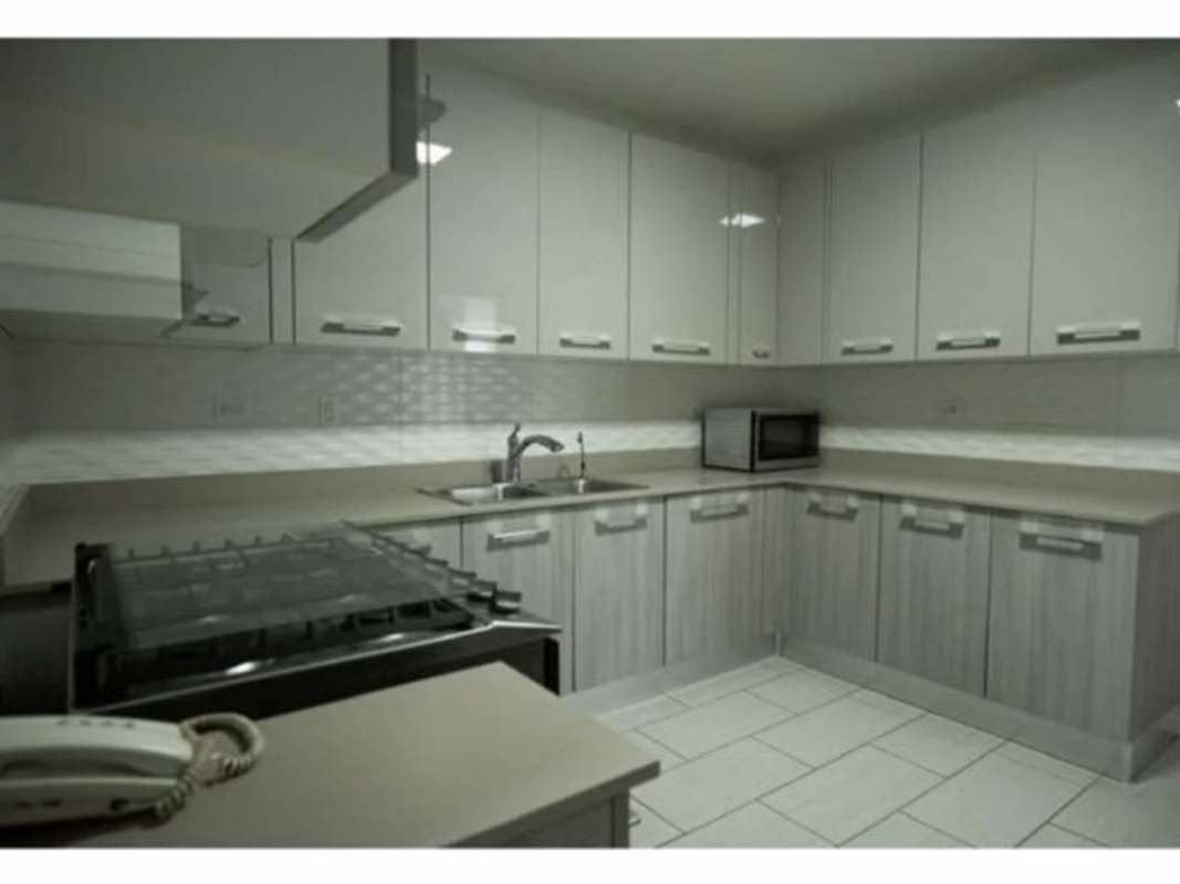 Spacious kitchen area with stainless steel refrigerator, gas stove, range hood PH The Towers Panama