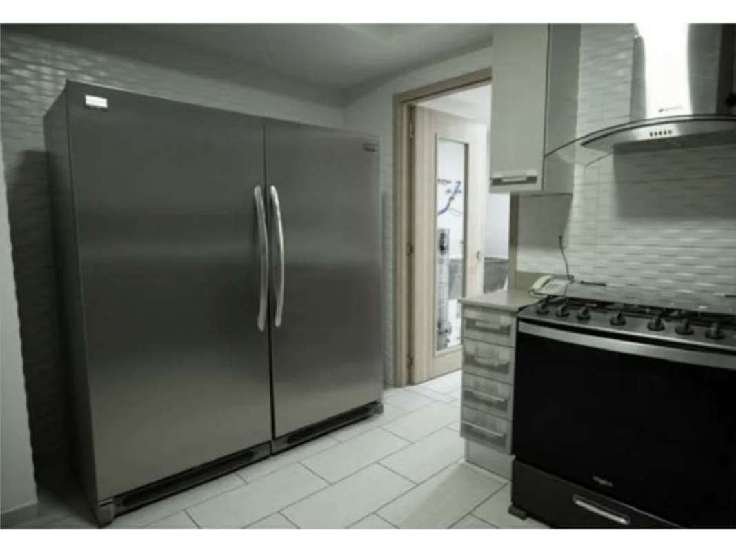 Elegant kitchen with granite counters, stove, stainless fridge PH The Towers Panama City