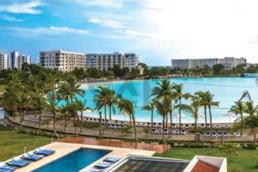 Large saltwater lagoon with beachfront and high-rise buildings at Playa Blanca Resort