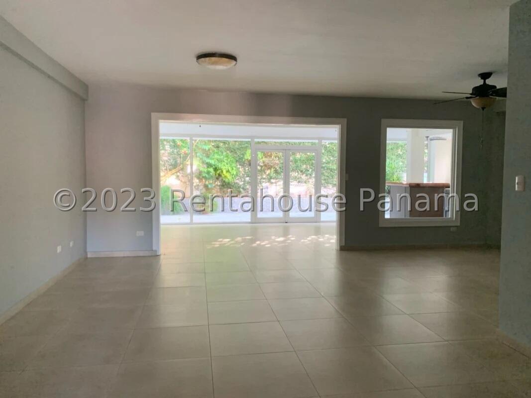 Spacious living area with large glass doors and tiled floors at La Alameda Betania Panama