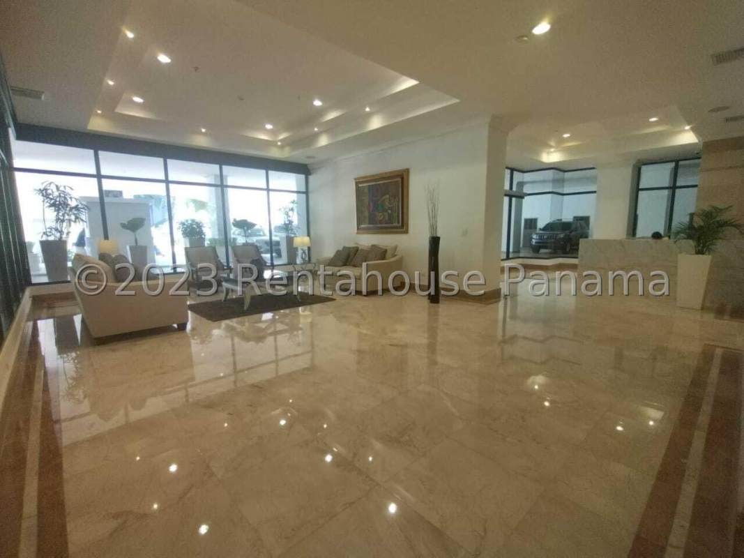 Elegant lobby with marble floors, large windows, seating area in PH Parque del Mar Panama
