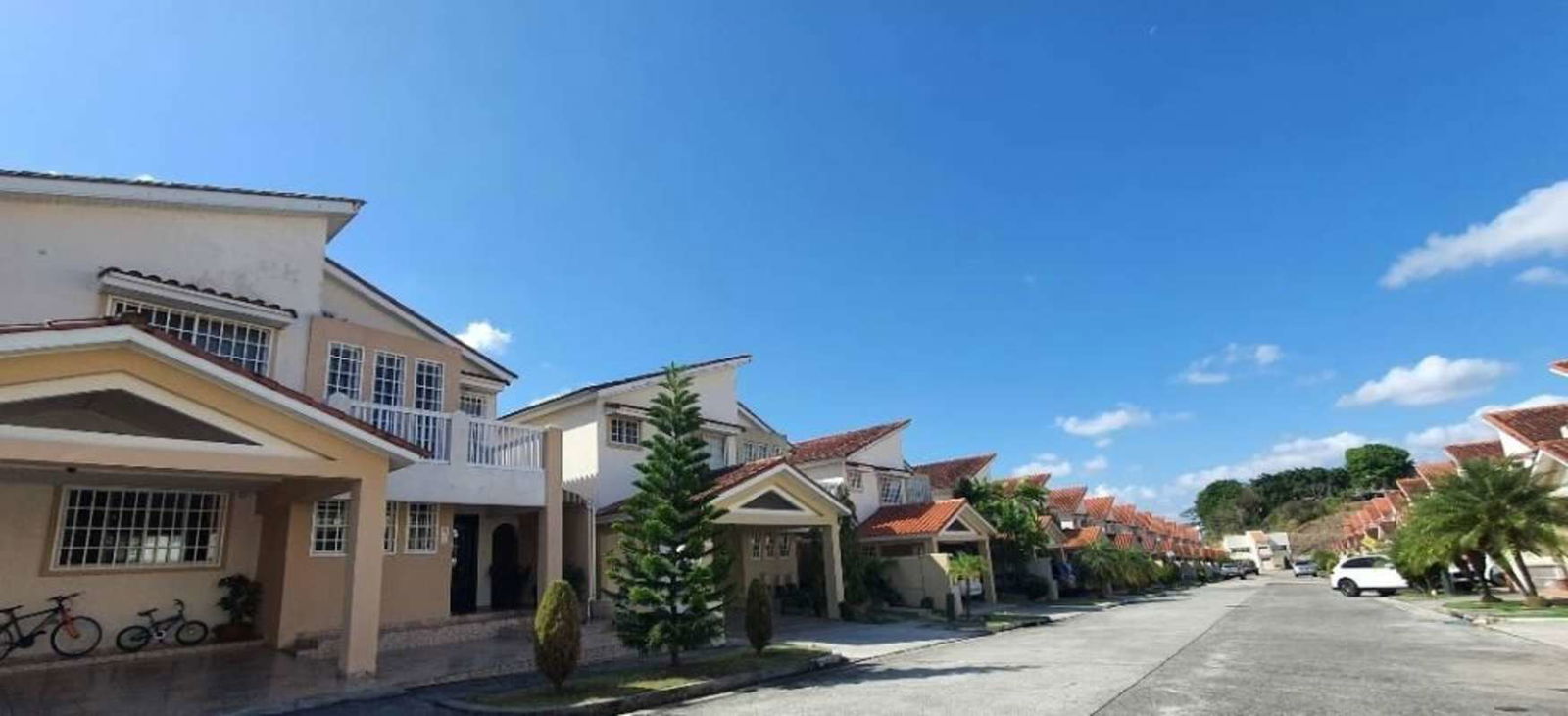 Exterior view of similar two-story houses with balconies and red tiled roofs in Brisas Heights neighborhood Panama City