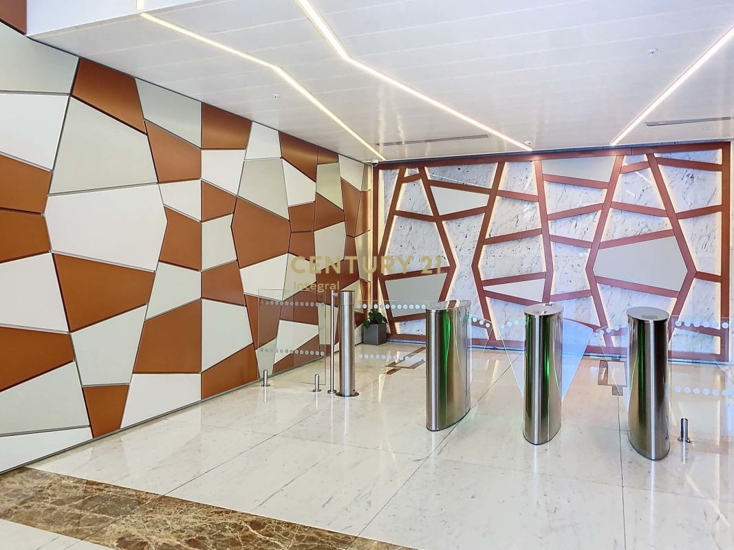 Marble and glass reception area with turnstiles at PH Atrium Tower Panama