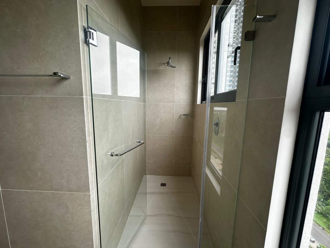 Bathroom with large window glass shower and vanity Ocean House Condo Panama