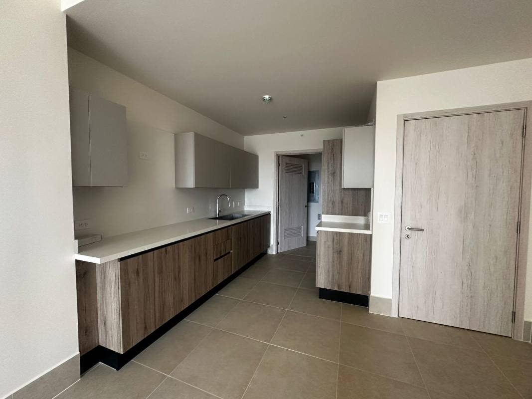 Modern kitchen with wood cabinets and porcelain flooring Ocean House Santa Maria