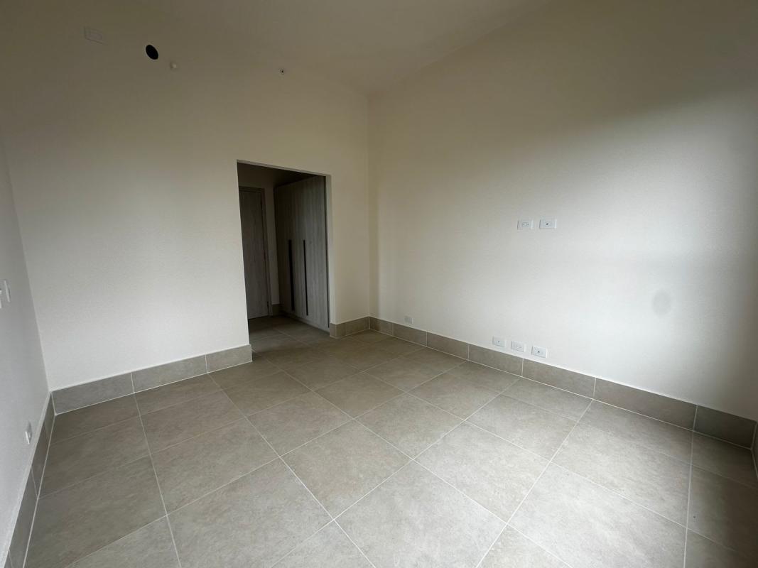 Spacious bedroom with panoramic window golf view PH Ocean House Panama