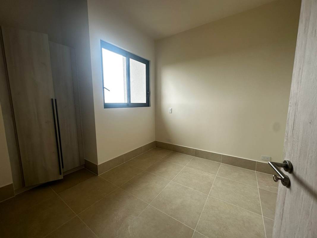 Bedroom with large window overlooking city modern condo Santa Maria