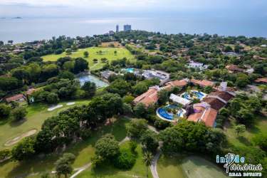 Large tropical swimming pool with palapas and deck chairs at Coronado Luxury Suites Resort Panama