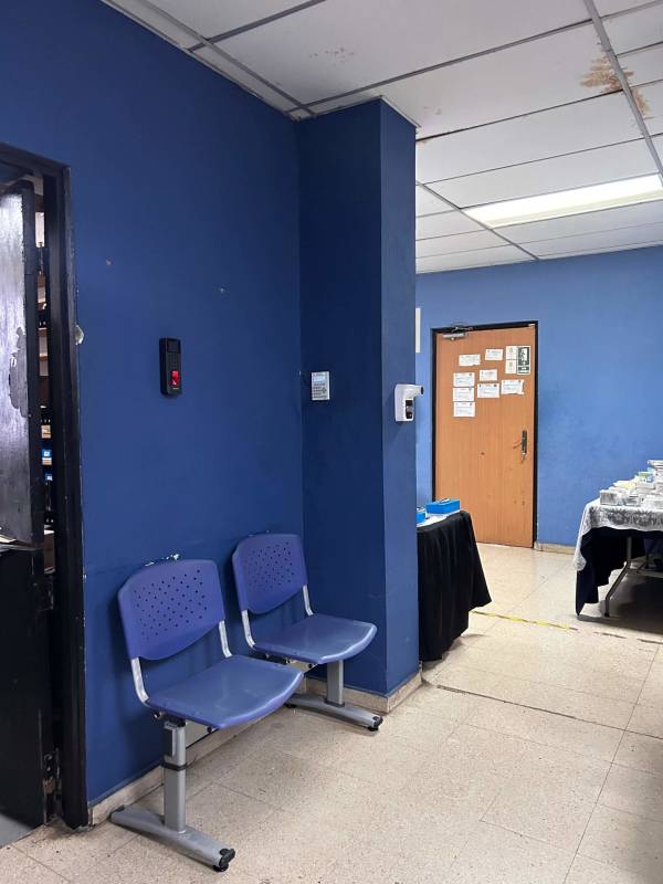 Office space interiors with blue walls inside commercial center for sale in Panama City