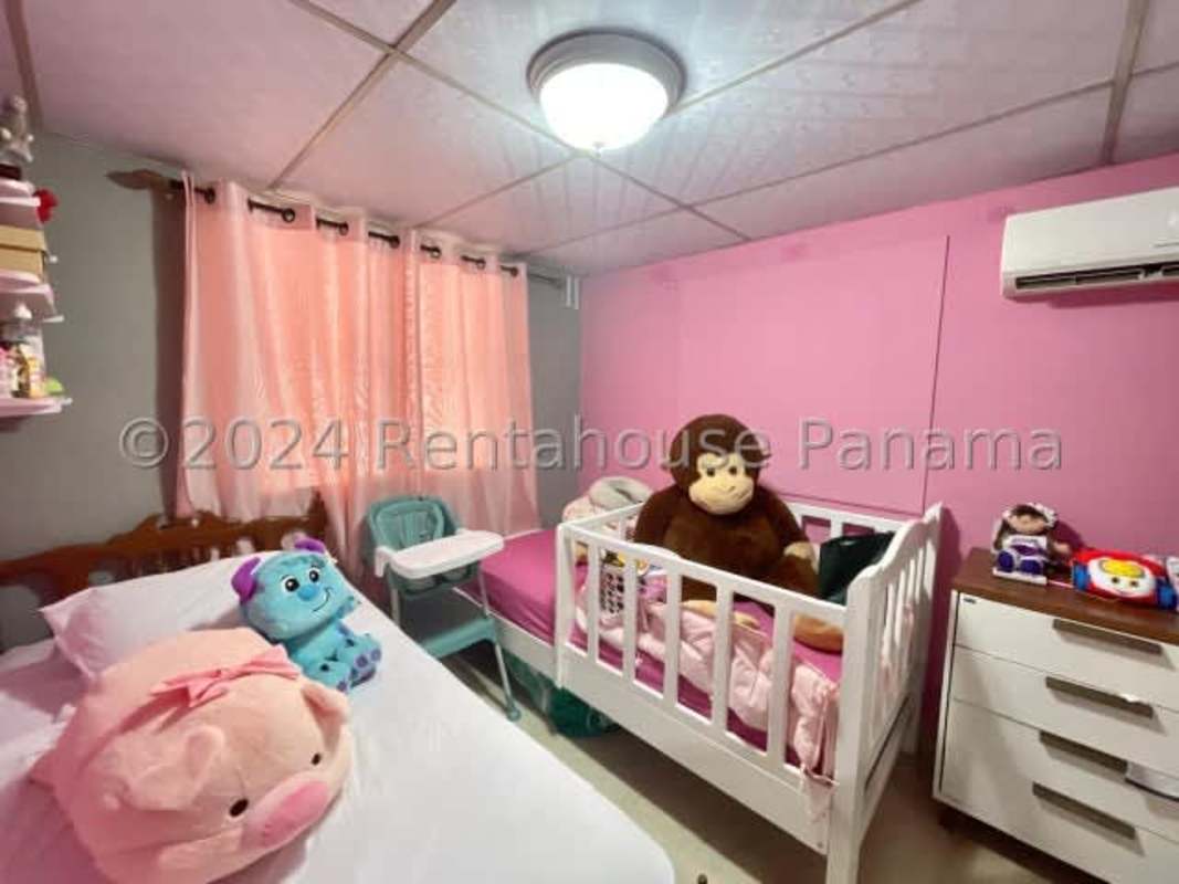 Contemporary kitchen with granite counters, dark wood cabinets in Don Bosco II house Panama City