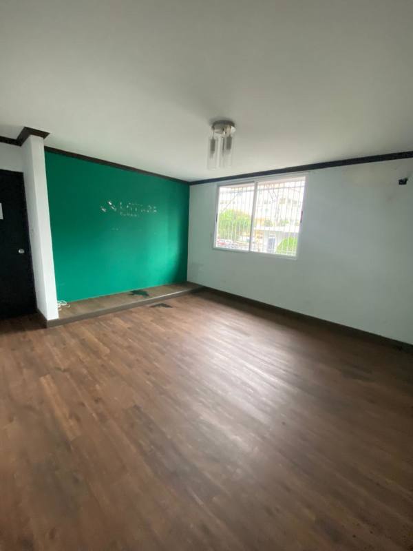 Minimalist kitchen with white cabinets and granite counters at corner commercial property Panama