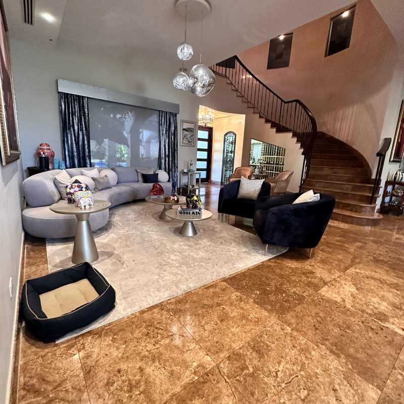 Luxury living room with curved sectional and marble floors in Villas del Mar Costa del Este Panama
