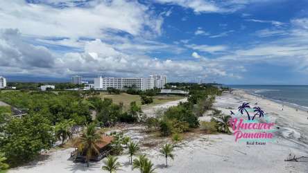 Modern living room with sliding glass doors leading to ocean-view balcony in Nikki Beach Playa Blanca Rio Hato