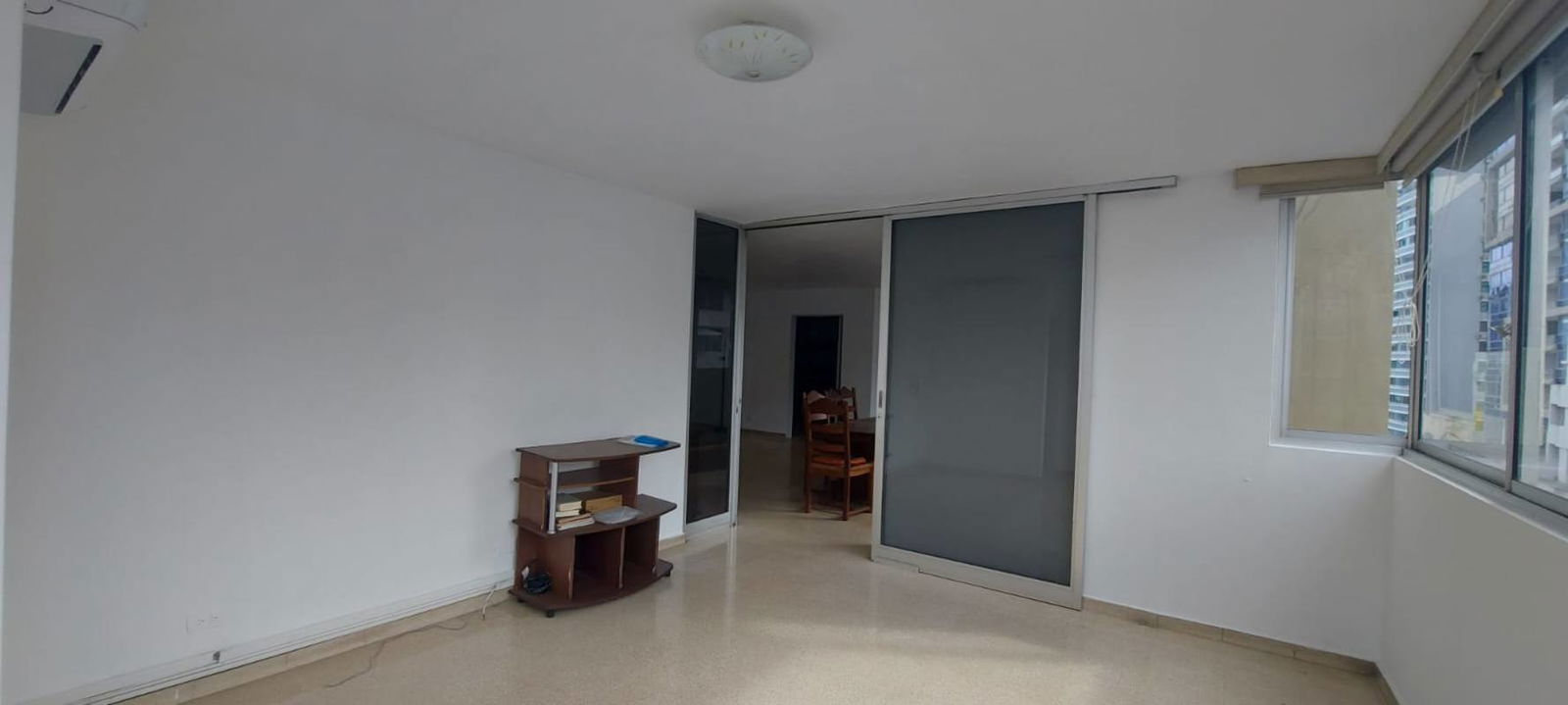 Open dining and living room with large windows city view PH La Concha Marbella Panama apartment for rent