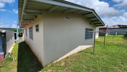 Private grassy backyard behind new house in La Alameda II Vista Alegre, Arraiján Panama