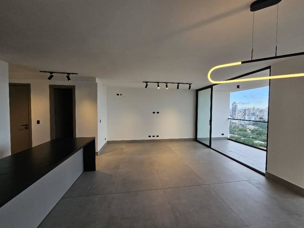 Bright apartment living room with city views through large windows Victory Wellness Panama