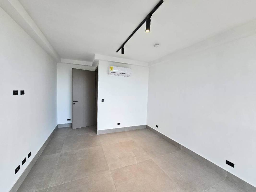 Modern spacious bedroom with AC and large window at Victory Wellness Coco del Mar Panama