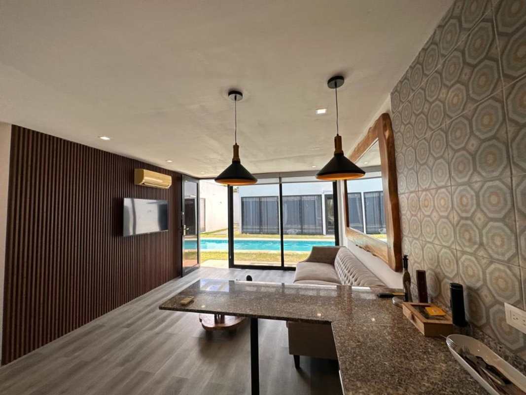 Integrated open space living room and kitchen with pool view in Bijao Resort Panama
