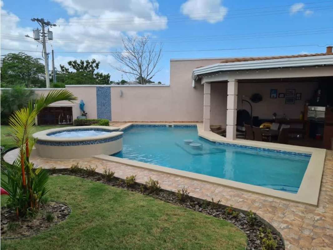 Private backyard featuring swimming pool and jacuzzi surrounded by garden Villa Navona Brisas del Golf Panama